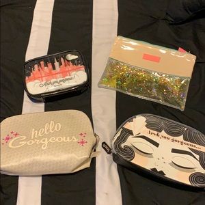 4 piece Benefit Cosmetics makeup bags